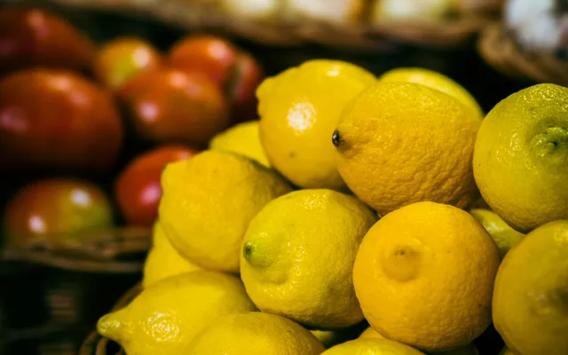 Limoni in un cesto in vendita e sullo sfondo altri prodotti